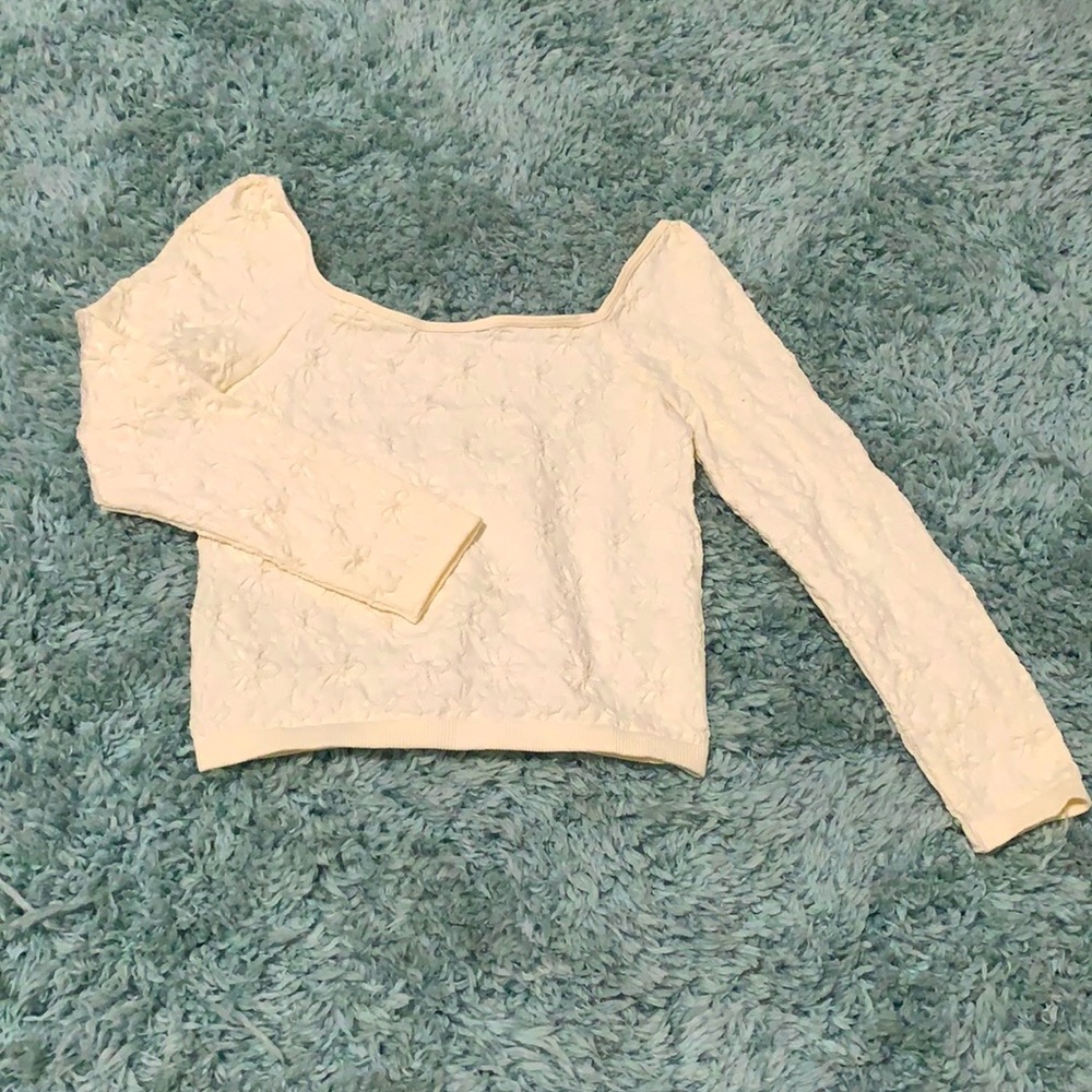 Creme colored wide chest blouse with flower detailing and elastic trim